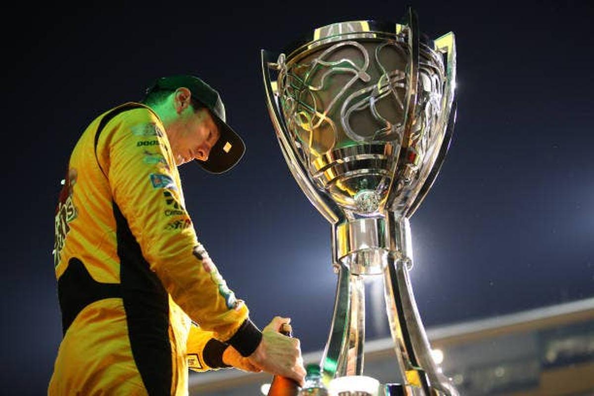  Kyle Busch stands next to the trophy after winning the NASCAR Cup Series championship.  (Photo by Chris Graythen/Getty Images)
