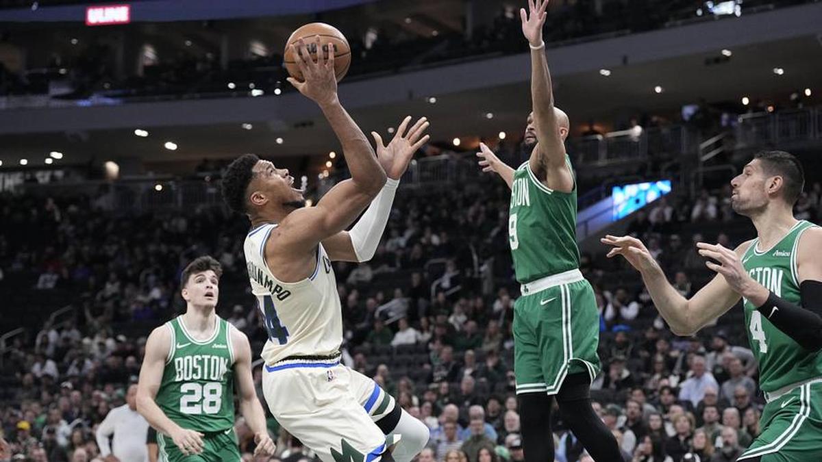  Mar 2, 2026; Milwaukee, Wisconsin, USA; Milwaukee Bucks forward Giannis Antetokounmpo (34) shoots against Boston Celtics guard Derrick White (9) in the first half at Fiserv Forum. | Michael McLoone-Imagn Images 