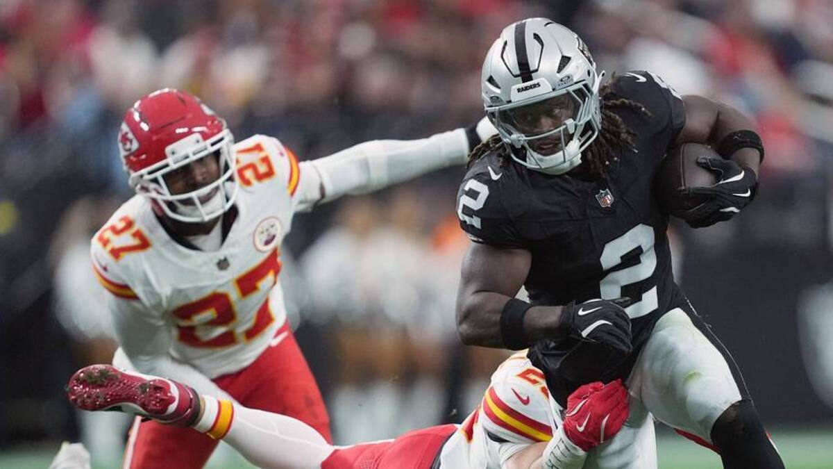  Jan 4, 2026; Paradise, Nevada, USA; Las Vegas Raiders running back Ashton Jeanty (2) carries the ball against Kansas City Chiefs linebacker Drue Tranquill (23) in the first half at Allegiant Stadium. Mandatory Credit: Kirby Lee-Imagn Images | Kirby Lee-Imagn Images 