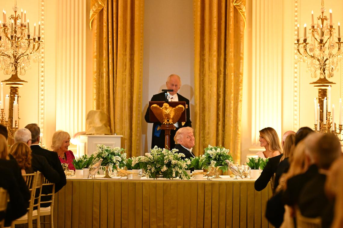 King Charles III of the United Kingdom speaks as, from left, Queen Camilla, President Donald Trump and first lady Melania Trump look on during a state dinner in the East Room of the White House in Washington, on Tuesday, April 28, 2026. (Kenny Holston/The New York Times)