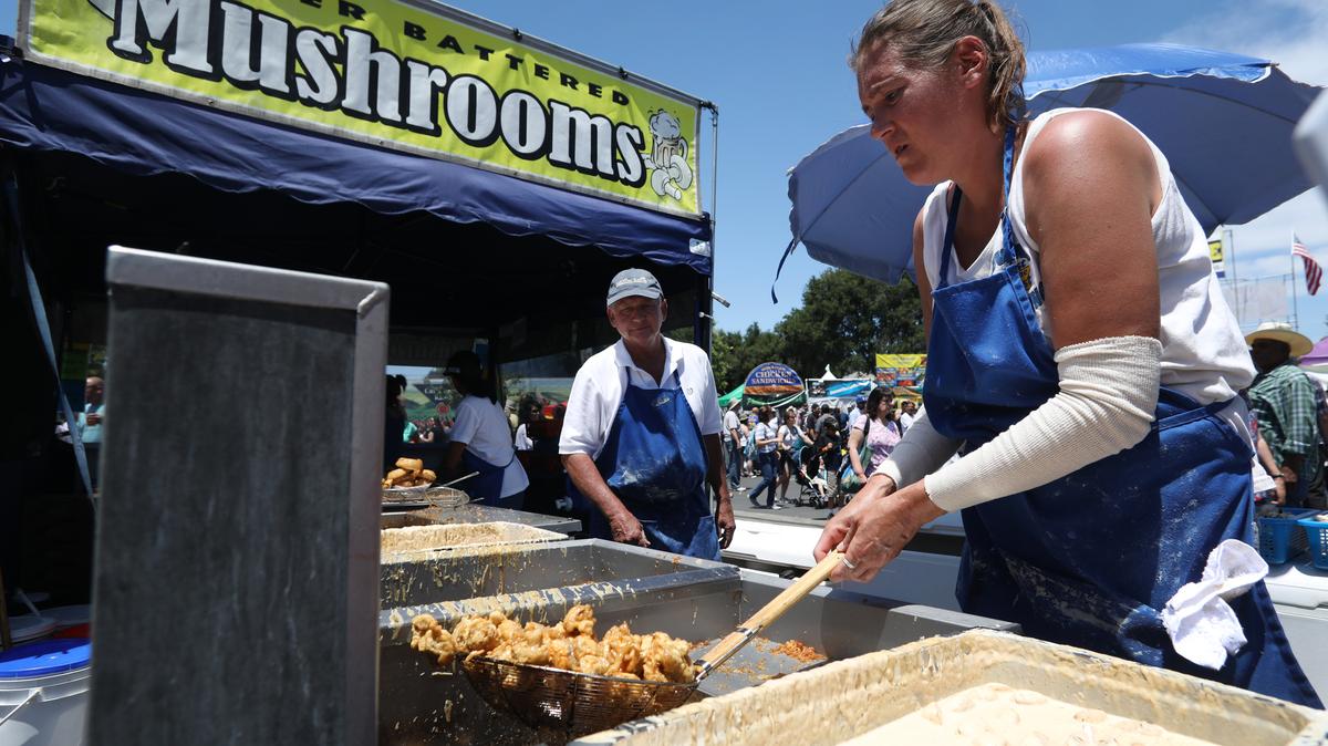 Jesse Hobson cooks beer battered mushrooms at the Mushroom Mardi Gras Festival in Morgan Hill, Calif., Sunday, May 27, 2018. (Karl Mondon/Bay Area News Group)