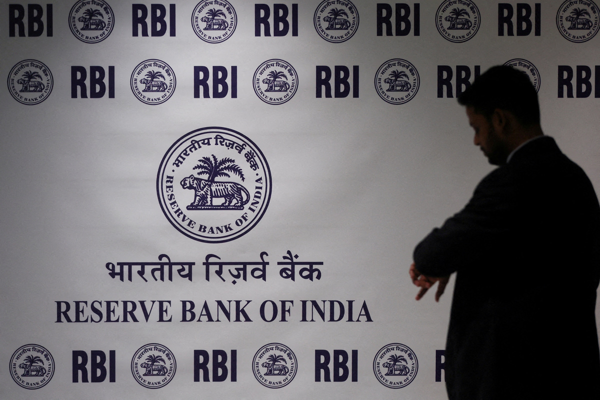 FILE PHOTO: man stands in front of the Reserve Bank of India (RBI) logo inside its headquarters in Mumbai, India, February 6, 2026. REUTERS/Francis Mascarenhas//File Photo