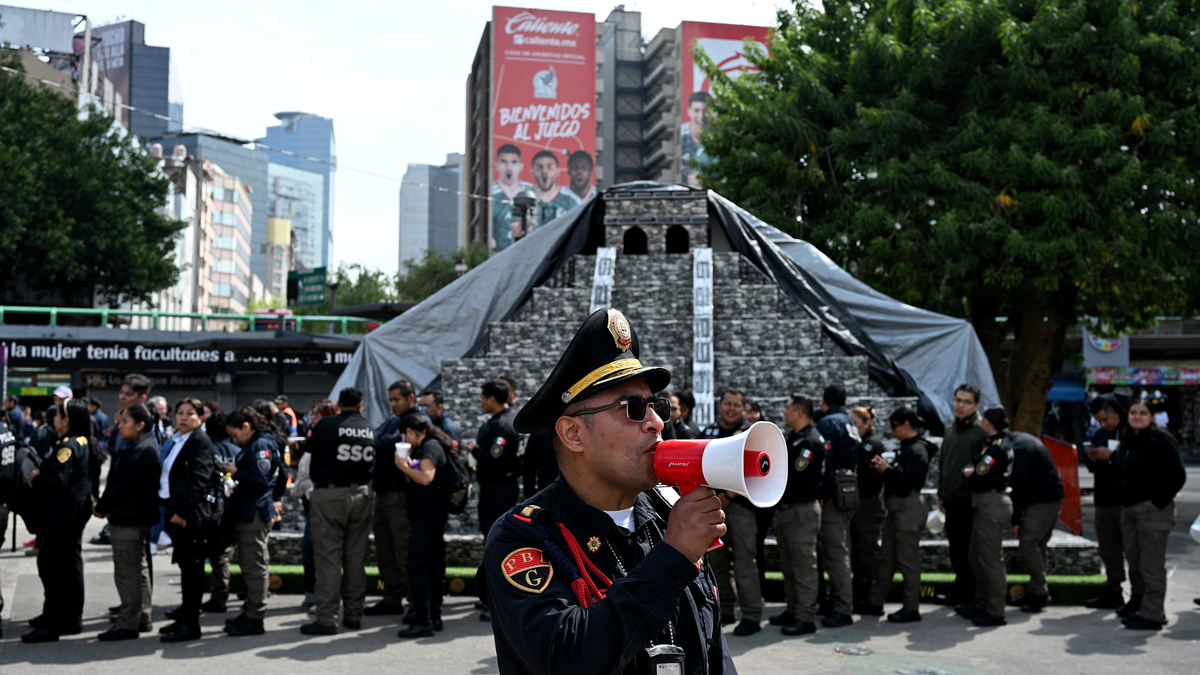 A member of the Secretariat of Citizen Security uses a megaphone to give instructions to personnel evacuated from several buildings following a preventive evacuation in Mexico City on July 17, 2026, after a 7.3-magnitude earthquake struck southern Mexico and parts of Central America. A magnitude 7.3 earthquake shook southern Mexico and parts of Central America on Friday, according to the U.S. Geological Survey (USGS), with no casualties reported so far. (Yuri Cortez/AFP/Getty Images/TNS)