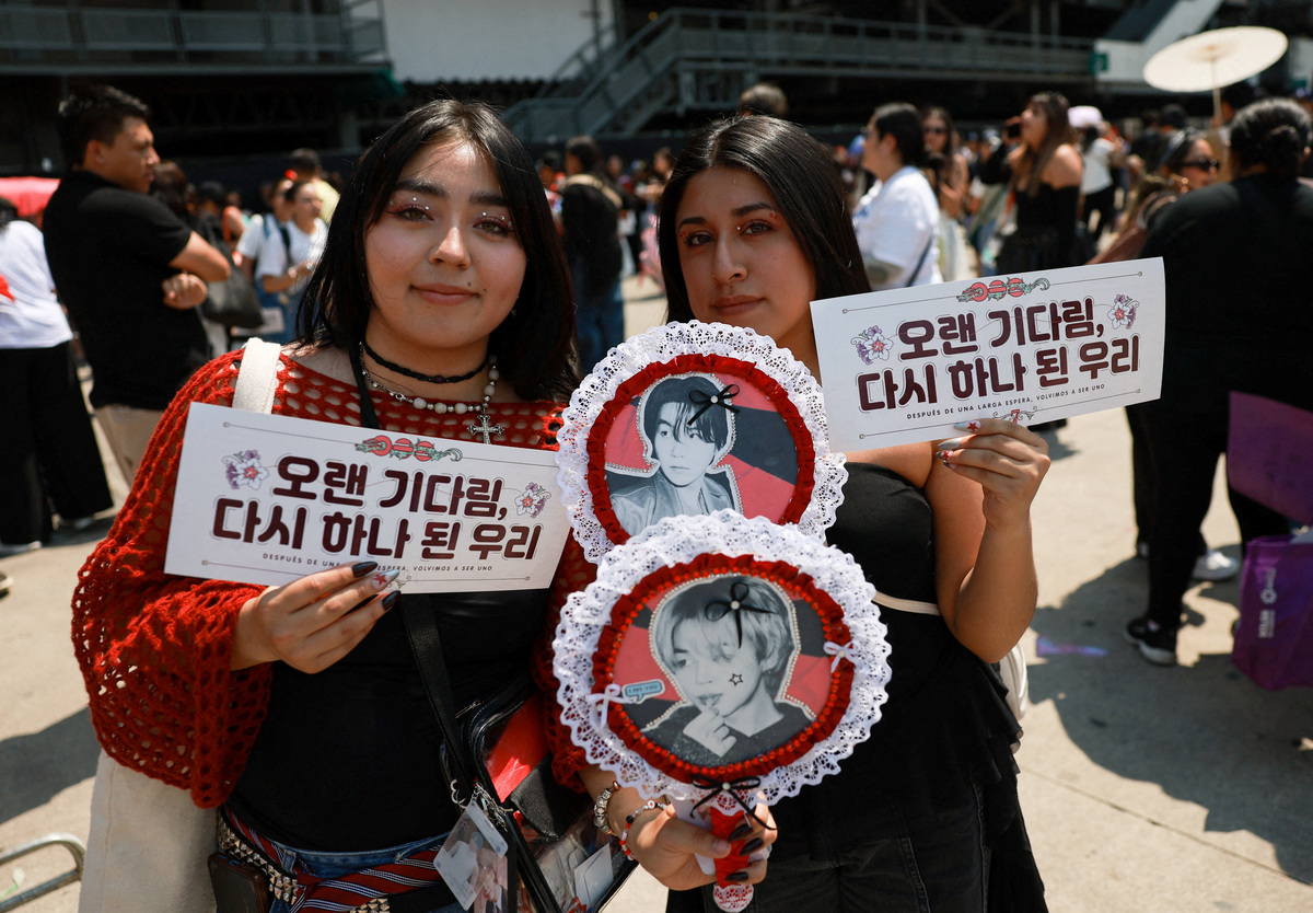 FILE PHOTO: Fans pose with signs at the venue before South Korean Kpop boy band BTS's concert, as the bond between Korea and Mexico, one of the world’s more unusual geo-cultural connections, continues to grow, with Korean influence gaining a foothold despite distance, language barriers and a 15-hour time difference, in Mexico City, Mexico, May 7, 2026. REUTERS/Henry Romero/File Photo