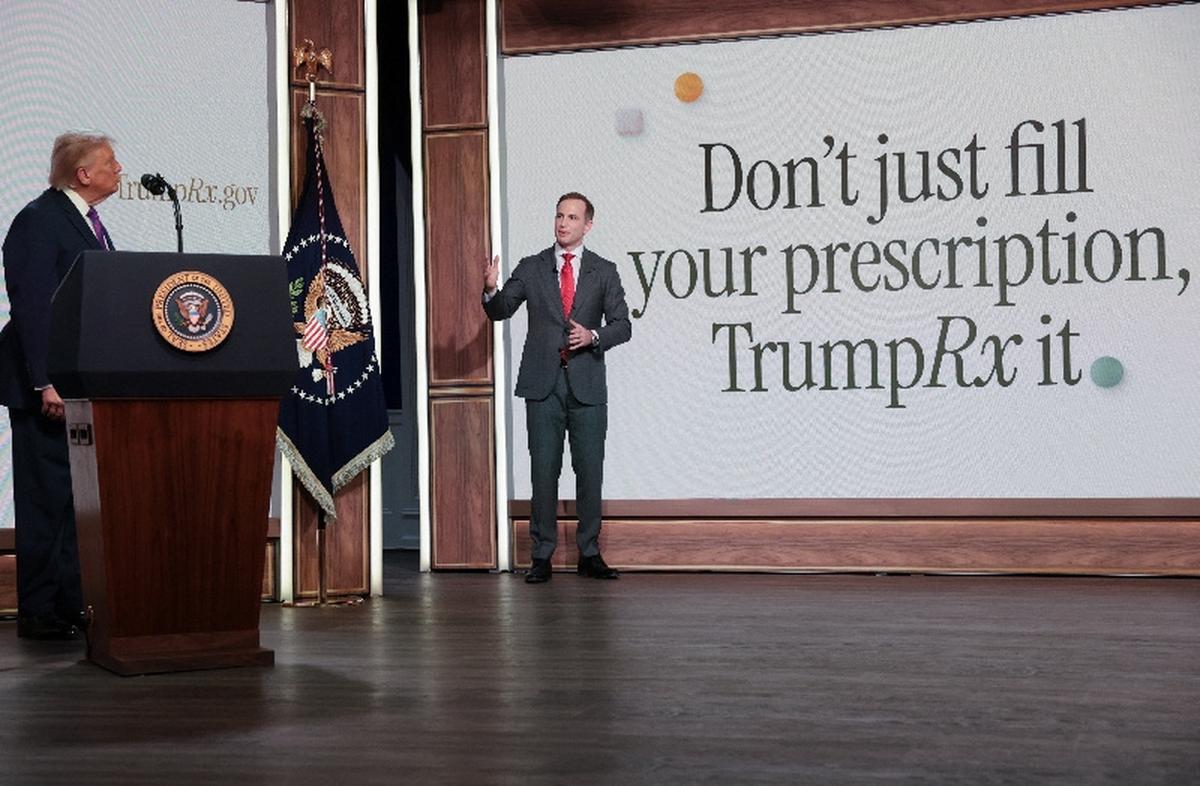 U.S. President Donald Trump looks at Chief Design Officer of the United States Joe Gebbia as he speaks during an event to deliver remarks about health care costs and affordability from an auditorium on the White House campus in Washington, D.C., U.S., May 18, 2026. REUTERS/Jonathan Ernst