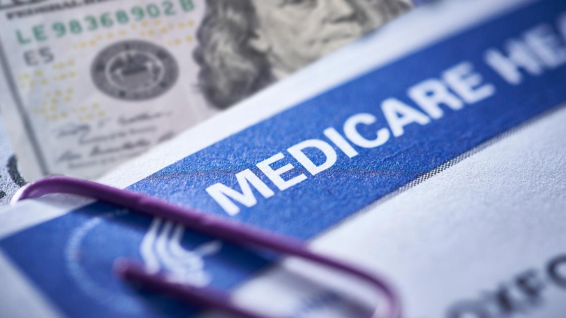 Medicare Card Health Insurance and money: $100 dollars. THE SEA RANCH, CALIFORNIA - November 12, 2018: Medicare Health Insurance and Social Security card on medical report with stethoscope. Medicare is a national health insurance program provided by the United States for seniors 65 and older.  Social Security is a federal insurance program that gives benefits to retired, unemployed and disabled people.