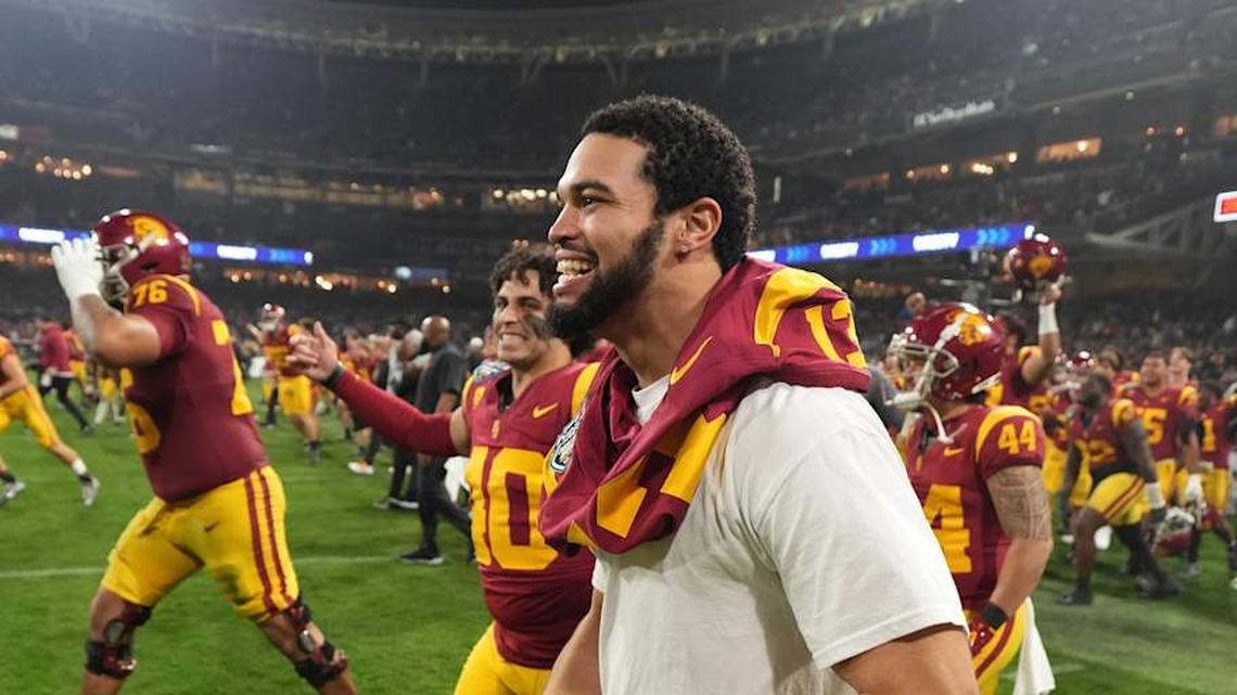  Dec 27, 2023; San Diego, CA, USA; Southern California Trojans quarterback Caleb Williams (13) celebrates after the Holiday Bowl against the Louisville Cardinals at Petco Park. Mandatory Credit: Kirby Lee-Imagn Images | Kirby Lee-Imagn Images 