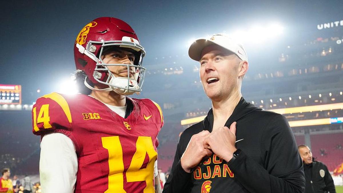  Nov 29, 2025; Los Angeles, California, USA; Southern California Trojans quarterback Jayden Maiava (14) and head coach Lincoln Riley react after the game against the UCLA Bruins at United Airlines Field at Los Angeles Memorial Coliseum. Mandatory Credit: Kirby Lee-Imagn Images | Kirby Lee-Imagn Images 