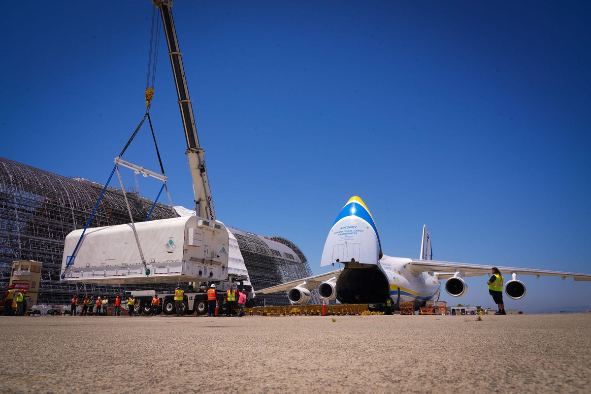 Ahead of a July 2023 launch aboard a SpaceX Falcon Heavy rocket from NASA's Kennedy Space Center, heavy equipment operators in California load the Jupiter 3 communications satellite inside a specialized container for transport aboard an Antonov AN-124-100.