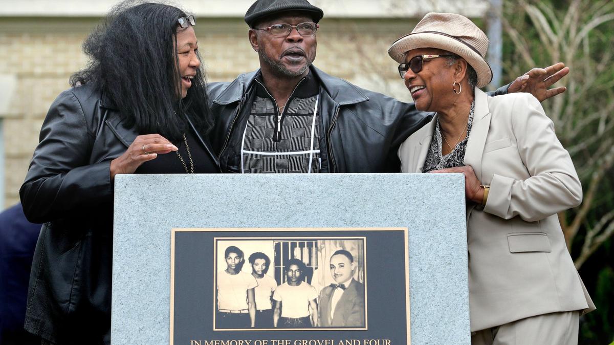 Relatives of the Groveland Four gather at the just-unveiled monument in front of the Lake County historical courthouse in Tavares, Florida, on Feb. 21, 2020. Gov. Ron DeSantis, elected officials and community leaders participated in the unveiling ceremony, honoring the four men who were falsely accused of a rape in 1949. From left, Vivian Shepherd, niece of Sam Shepherd; Gerald Threat, nephew of Walter Irvin; Carol Greenlee, daughter of Charles Greenlee. (Joe Burbank/Orlando Sentinel/TNS)