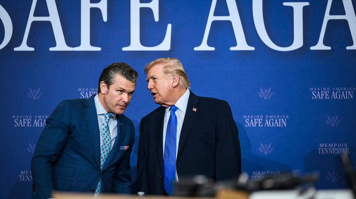 U.S. President Donald Trump speaks with Secretary of Defense Pete Hegseth during the Memphis Safe Task Force roundtable on public safety at the Tennessee Air National Guard Base.