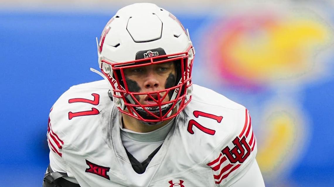  Nov 28, 2025; Lawrence, Kansas, USA; Utah Utes offensive lineman Caleb Lomu (71) gets ready before the snap during the second half against the Kansas Jayhawks at David Booth Kansas Memorial Stadium. Mandatory Credit: Jay Biggerstaff-Imagn Images | Jay Biggerstaff-Imagn Images 