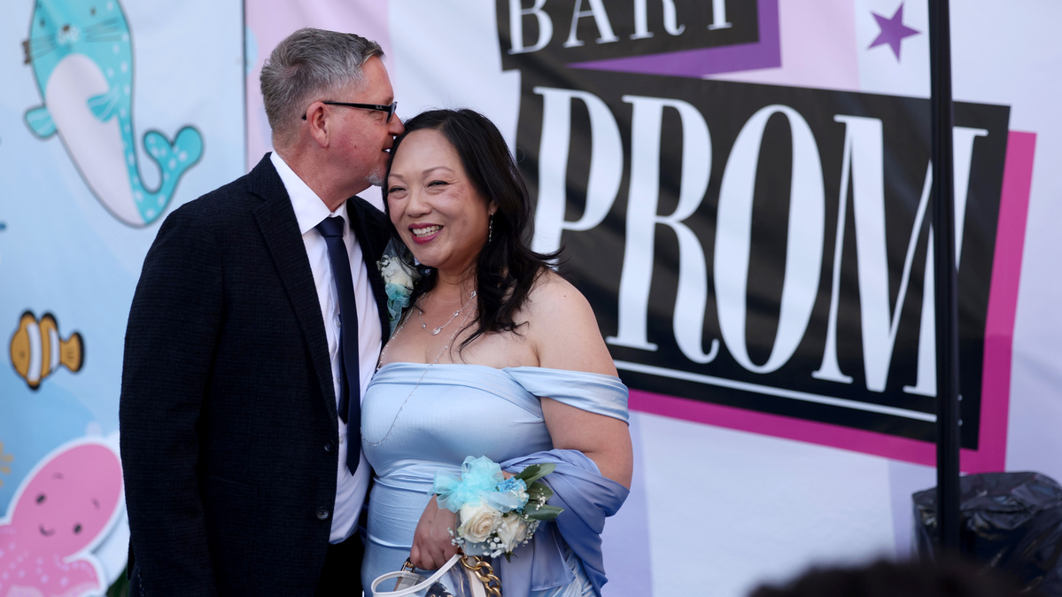 Frank Hansen and his partner Vivian Wong, of Benicia, share a moment during the BART Prom at the Rockridge BART station Oakland, Calif., on Saturday, June 6, 2026. The first-ever event had an 1980’s and under-the-sea theme and sold out. They went to Benicia High School together, but didn’t go to the prom until now. (Jane Tyska/Bay Area News Group)