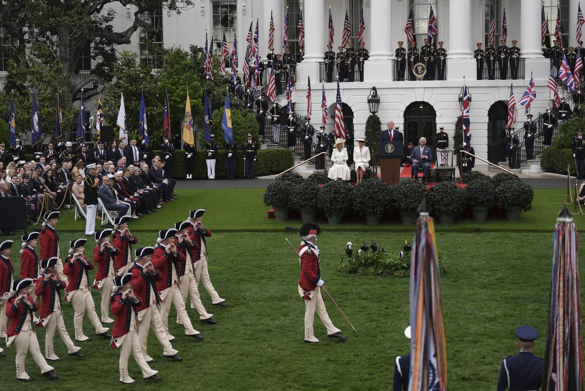 From right: King Charles III, President Donald Trump, first lady Melania Trump and Queen Camilla watch as members of the U.S. Army Old Guard Fife and Drum Corps perform during an arrival ceremony on the South Lawn of the White House in Washington, on Tuesday, April 28, 2026. (Salwan Georges/The New York Times)