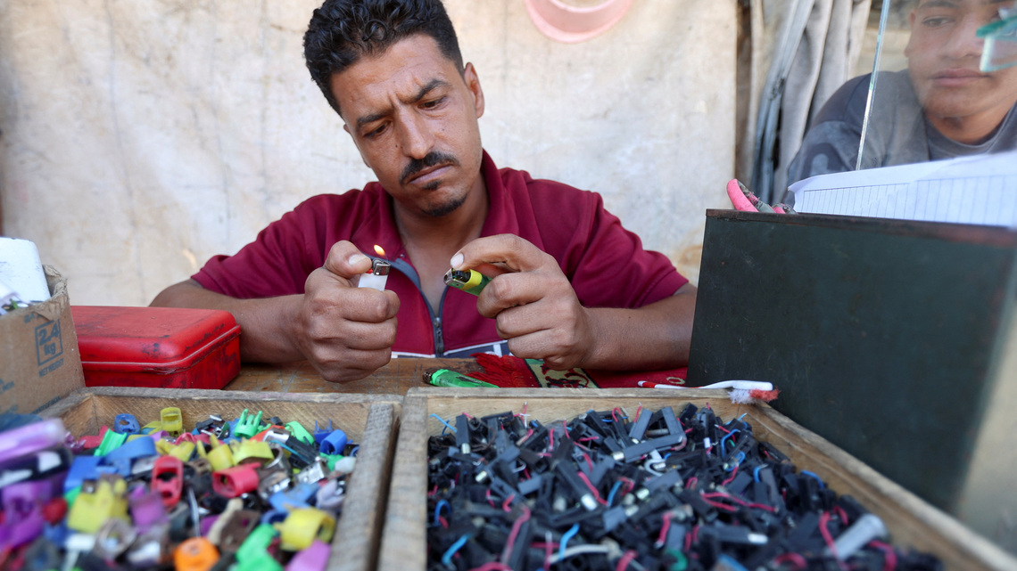 In Gaza's tent camps, a cigarette lighter becomes a lifeline 