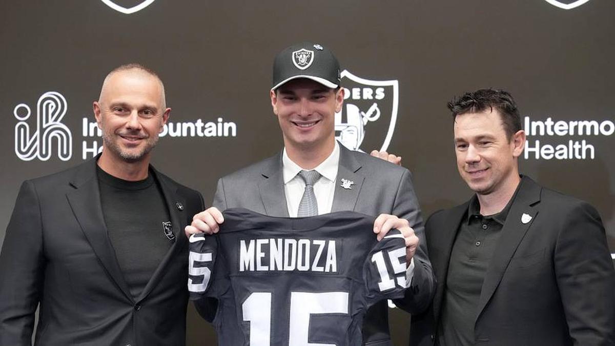  Apr 24, 2026; Henderson, NV, USA; Las Vegas Raiders quarterback Fernando Mendoza (center) poses with general manager John Spytek (left) and head coach Klint Kubiak at introductory press conference at Intermountain Health Performance Center after being selected as the No. 1 pick in the 2026 NFL Draft. Mandatory Credit: Kirby Lee-Imagn Images | Kirby Lee-Imagn Images 