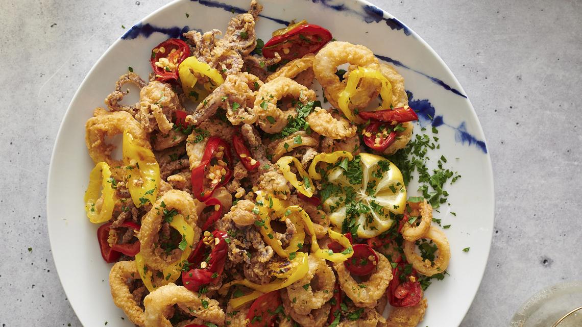 This image shows a recipe for Rhode Island–Style Fried Calamari by Dan Rinaldi, a firefighter in Providence, R.I., from “The Great American Recipe Cookbook,” a new PBS series that gathers 10 home cooks from all over the country and gives them the opportunity to showcase their beloved signature dishes. (Fred + Elliott via AP)