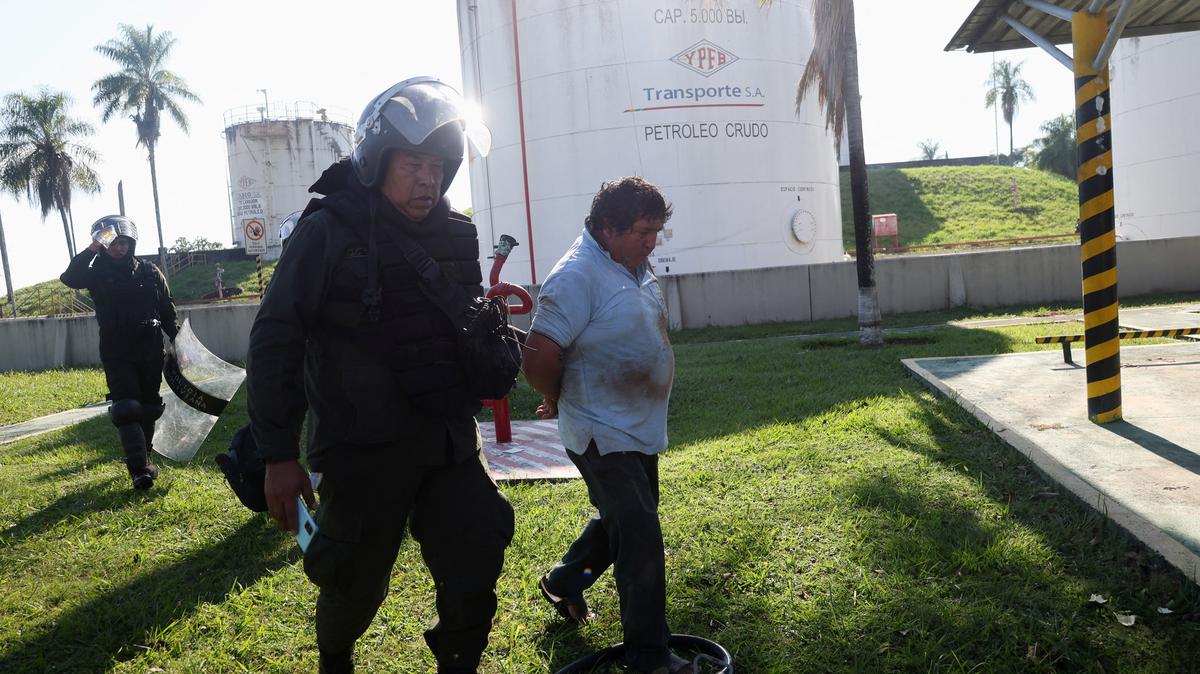 Police officers detain a protester while dislodging community members who seized the Humberto Suarez oil facility to call for the resignation of President Rodrigo Paz, as ongoing protests have led to shortages of fuel and food, in Santa Rosa del Sara, Bolivia June 3, 2026. REUTERS/Ipa Ibanez
