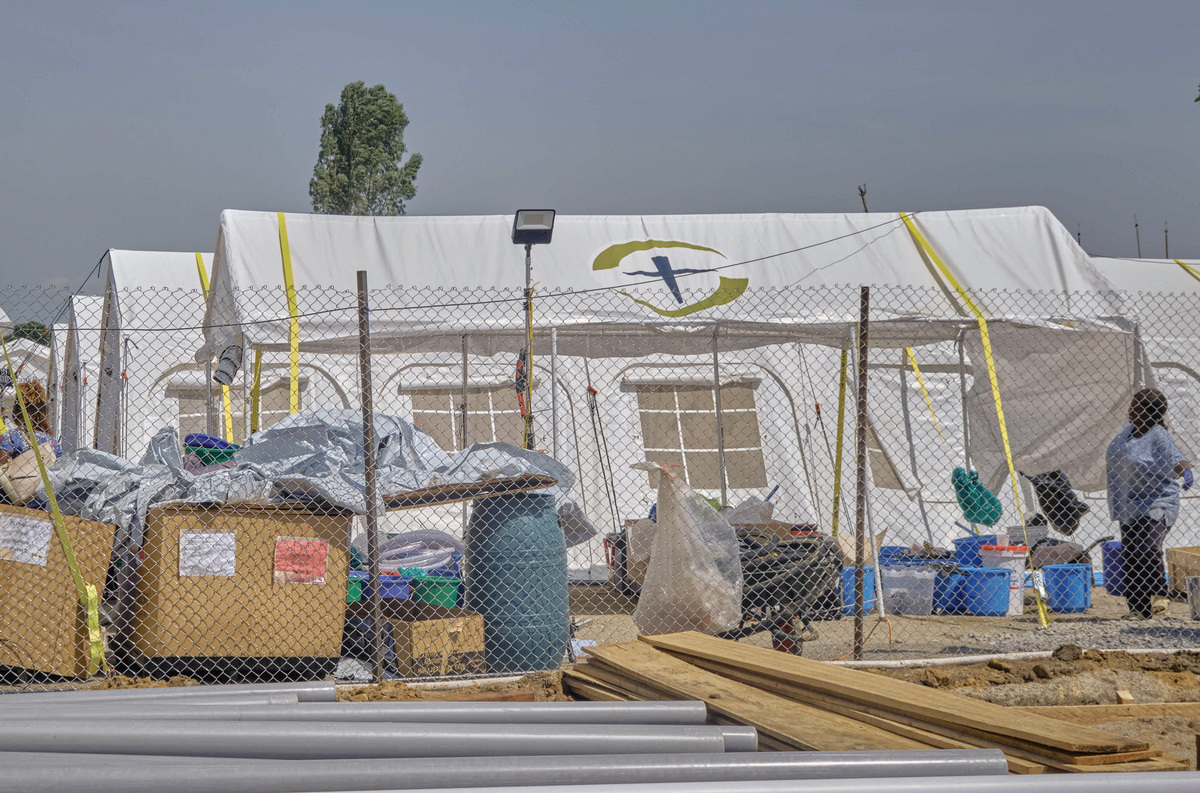 A woman stands by the newly built tents by the Samaritan's Purse International Relief, at the Scott Powell Memorial Ebola Treatment Center, as aid agencies intensify efforts to contain the Ebola outbreak caused by the Bundibugyo virus, in Bunia town, Ituri province, Democratic Republic of Congo, June 11, 2026. REUTERS/Gradel Muyisa Mumbere