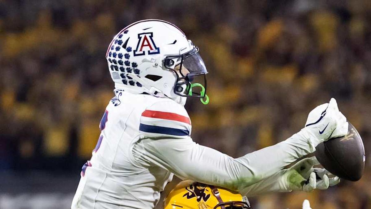  Nov 28, 2025; Tempe, Arizona, USA; Arizona Wildcats defensive back Treydan Stukes (2) intercepts the ball against Arizona State Sun Devils wide receiver Jaren Hamilton (16) in the second half during the 99th Territorial Cup at Mountain America Stadium. Mandatory Credit: Mark J. Rebilas-Imagn Images | Mark J. Rebilas-Imagn Images 