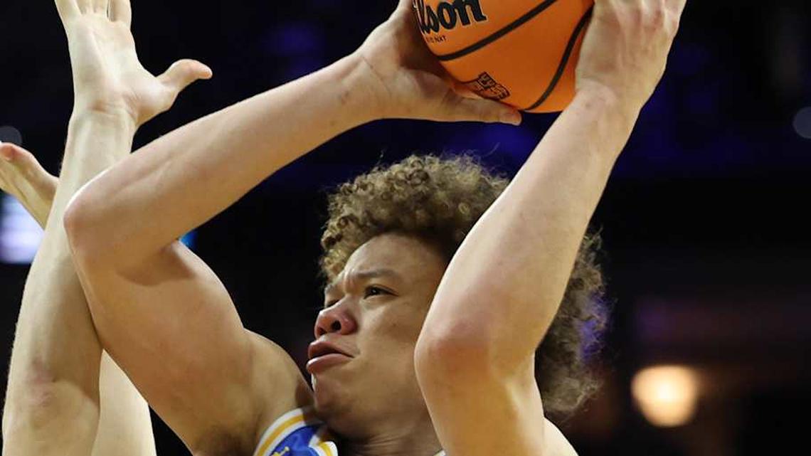  Mar 22, 2026; Philadelphia, PA, USA; UCLA Bruins guard Trent Perry (0) shoots the ball on UConn Huskies guard Braylon Mullins (24) in the second half during a second round game of the men's 2026 NCAA Tournament at Xfinity Mobile Arena. Mandatory Credit: Bill Streicher-Imagn Images | Bill Streicher-Imagn Images 