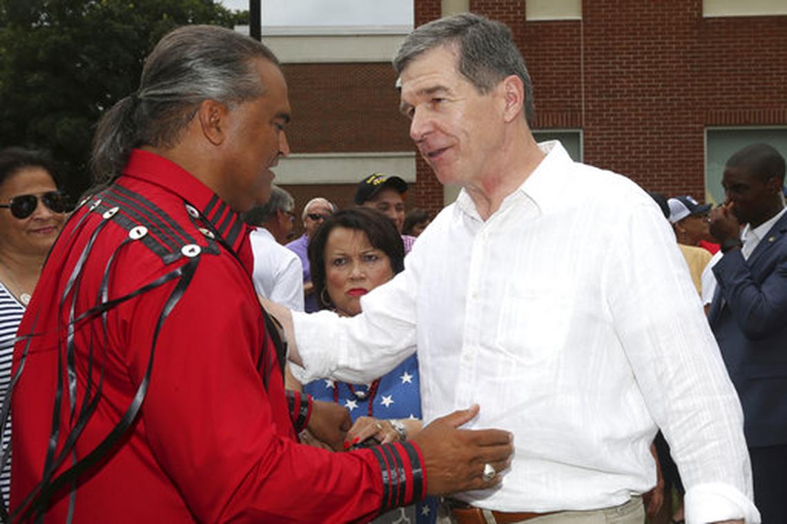 North Carolina Gov. Roy Cooper speaks with Lumbee Tribal Chairman Harvey Goodwin during the American Indian Science and Engineering Society (AISES) Powwow on the last day of the 50th annual Lumbee Homecoming on the campus of UNC-Pembroke on Saturday, July 7, 2018, in Pembroke, N.C. Cooper promised people in southern North Carolina he will do all he can to make sure they recover from flooding from Hurricane Matthew.