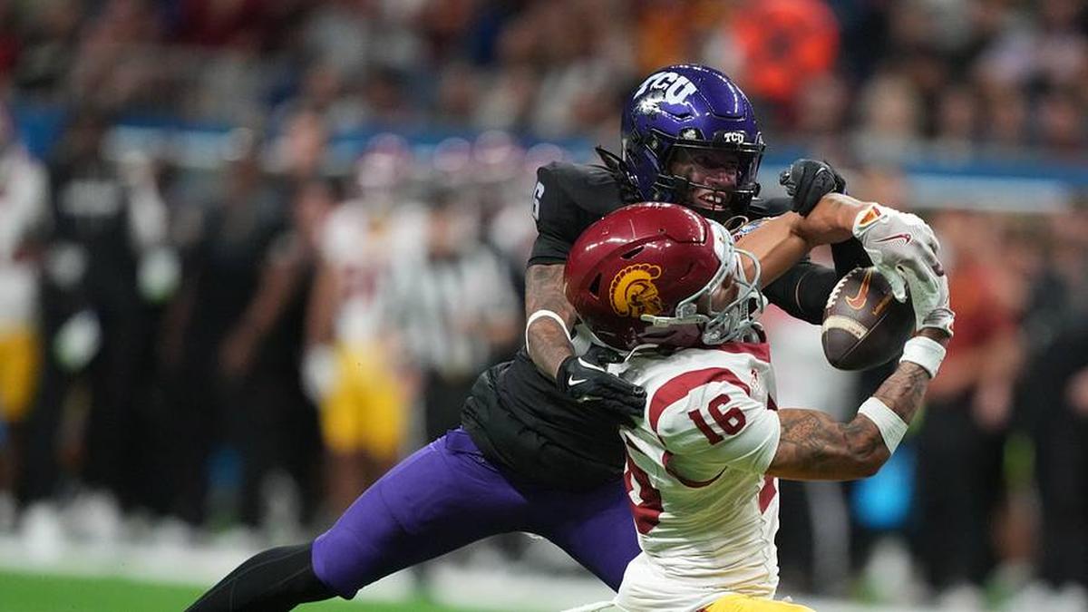 Dec 30, 2025; San Antonio, TX, USA; Southern California Trojans wide receiver Tanook Hines (16) catches the ball against TCU Horned Frogs cornerback Vernon Glover (26) in the second half during the Alamo Bowl at Alamodome. Mandatory Credit: Kirby Lee-Imagn Images | Kirby Lee-Imagn Images 