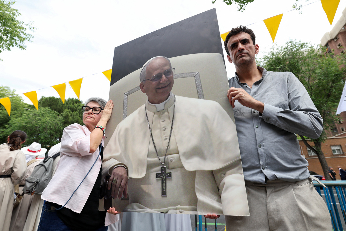 Miguel Hurtado, who alleges abuse by a priest at Montserrat Abbey and is a representative for the platform "Full Reparation Now" to support victims of sexual abuse in the Catholic Church, holds a placard with a picture of Pope Leo XIV next to Maria Dantas, during a protest for victims of clerical sexual abuse in front of the Apostolic Nunciature, where Pope is staying during his apostolic journey in Spain, in Madrid, Spain June 7, 2026. REUTERS/Violeta Santos Moura