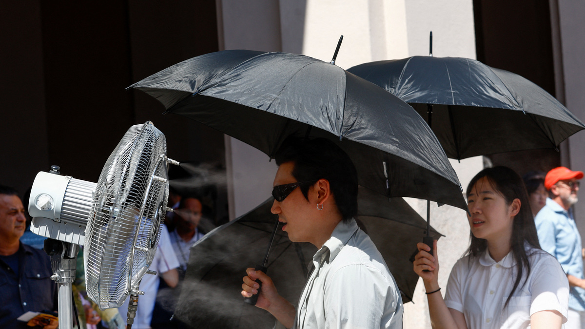 A man stands in front of a cooler spraying water ahead of Thom Browne’s Spring/Summer 2027 men’s collection show as part of Milan Fashion Week, in Milan, Italy, June 22, 2026. REUTERS/Alessandro Garofalo