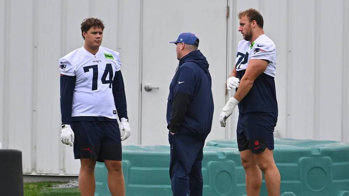  May 9, 2026; Foxborough, MA, USA; New England Patriots 2025-2026 tackle Caleb Lomu (74) talks to a member of the coaching staff and tackle Lorenz Metz (72) during the New England Patriots rookie camp at Gillette Stadium. Mandatory Credit: Eric Canha-Imagn Images | Eric Canha-Imagn Images 