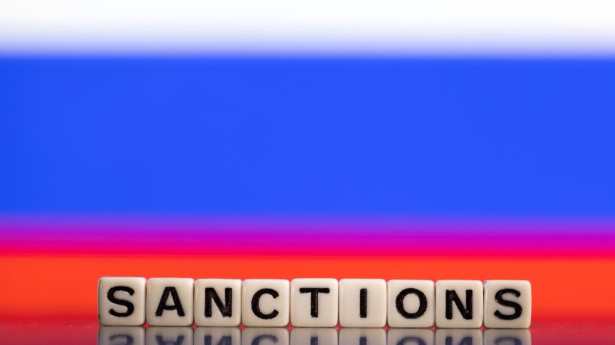 Plastic letters arranged to read "Sanctions" are placed in front of Russian flag colors in this illustration taken February 25, 2022. REUTERS/Dado Ruvic/Illustration