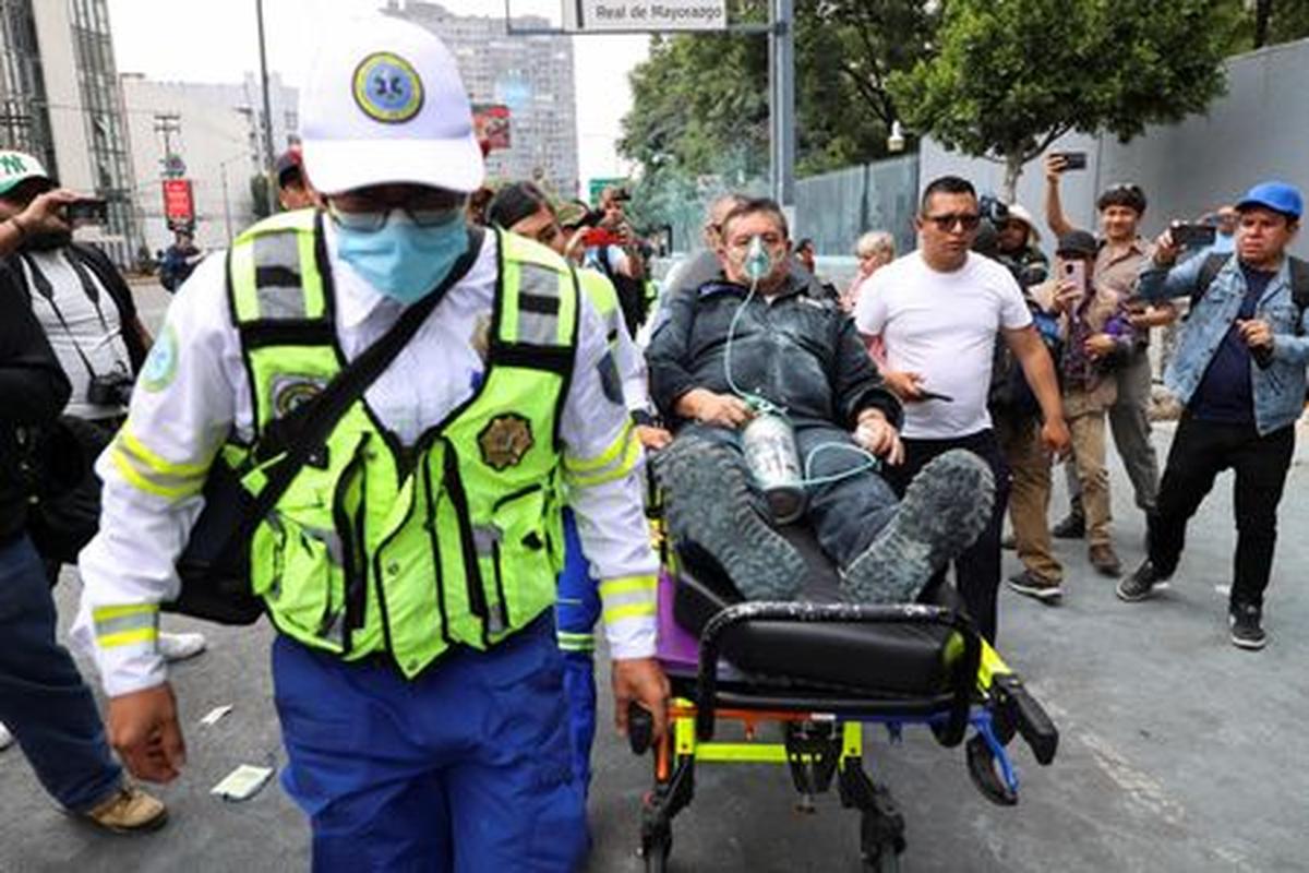 An auxiliary police officer is evacuated from the Secretariat of Public Education (SEP) by emergency personnel after dissident teachers from Mexico's National Coordination of Education Workers (CNTE) vandalized the building of the SEP during a protest to demand better wages and pensions, under the slogan "If there's no solution, the ball won't roll," ahead of the 2026 FIFA World Cup, in Mexico City, Mexico, June 3, 2026. REUTERS/Luis Cortes