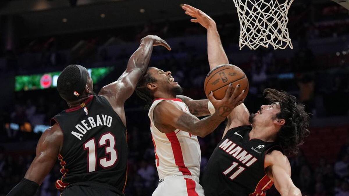  Mar 21, 2025; Miami, Florida, USA; Houston Rockets guard Jalen Green (4) drives to the basket as Miami Heat guard Jaime Jaquez Jr. (11) and center Bam Adebayo (13) defend in the first half at Kaseya Center. Mandatory Credit: Jim Rassol-Imagn Images | Jim Rassol-Imagn Images 