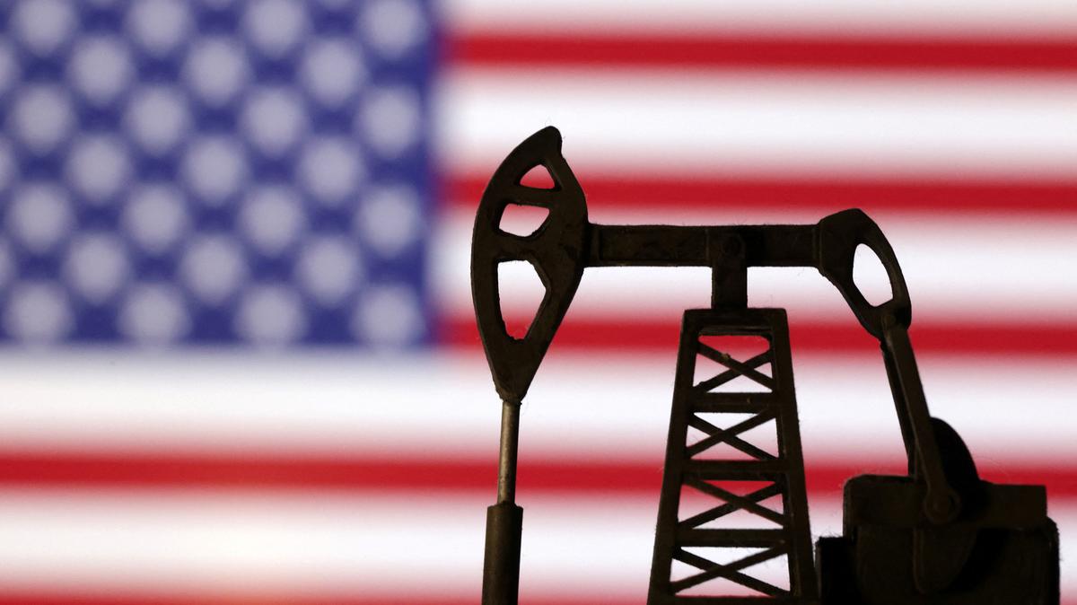 Oil pump jack is seen in front of displayed U.S. flag in this illustration taken, October 8, 2023. REUTERS/Dado Ruvic/Illustration