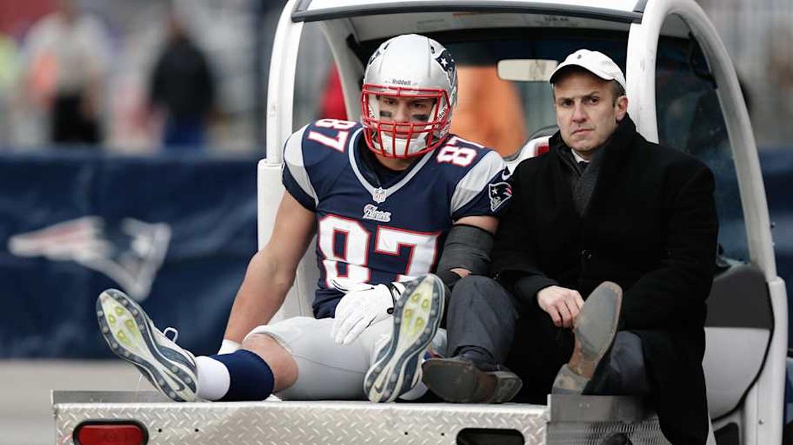  Dec 8, 2013; Foxborough, MA, USA; New England Patriots tight end Rob Gronkowski (87), accompanied by Dr. Thomas Gill, is carted off the field after being injured during the third quarter of New England's 27-26 win over the Cleveland Browns at Gillette Stadium. Mandatory Credit: Winslow Townson-Imagn Images | Winslow Townson-Imagn Images 