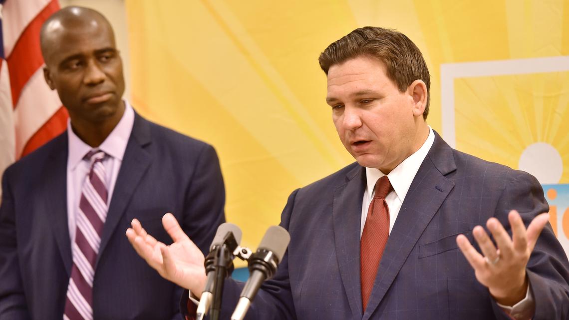 Florida Gov. Ron DeSantis addresses the media as Dr. Joseph Ladapo, Florida surgeon general, looks on during a news conference in Jacksonville, Fla., on Tuesday, Jan. 4, 2022.
