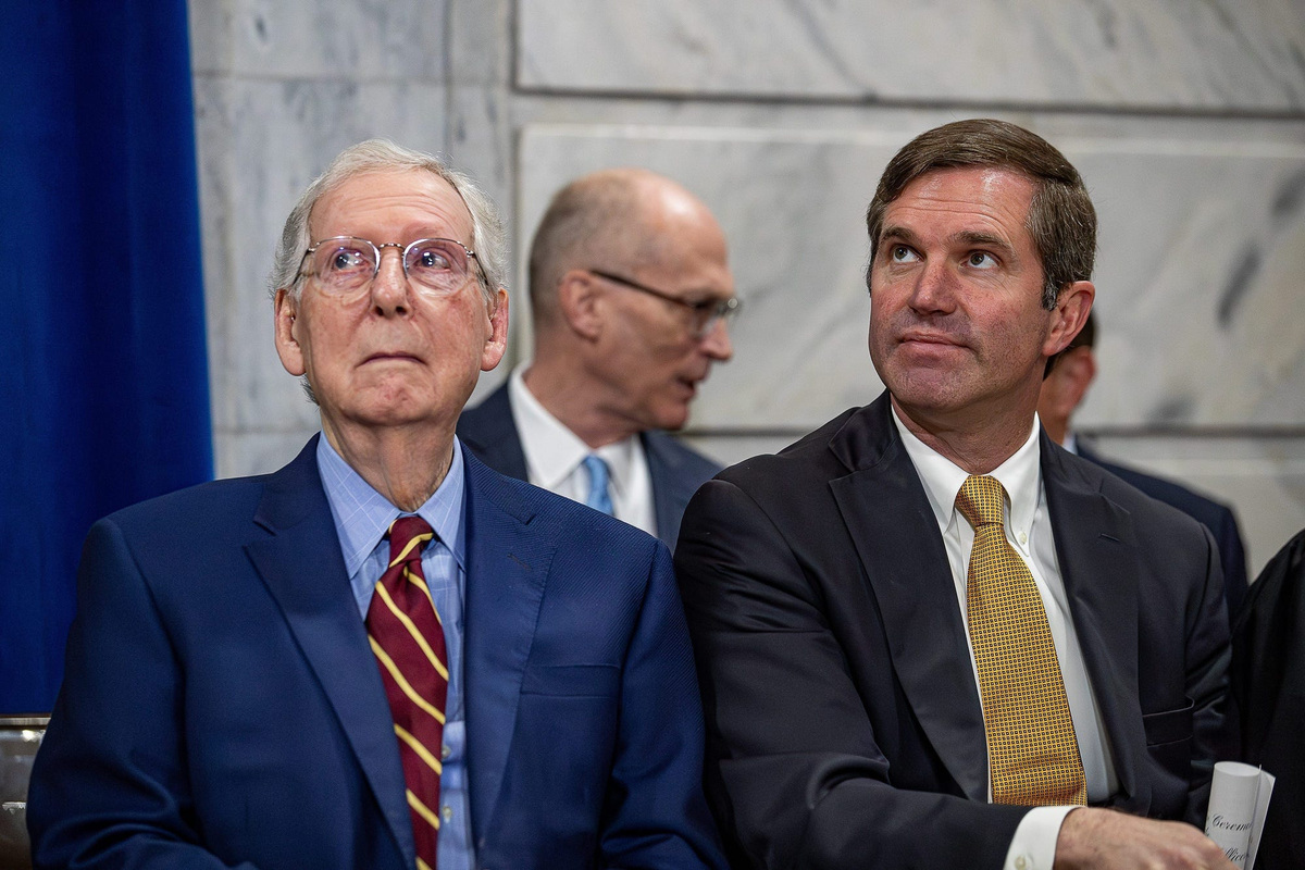 Sen. Mitch McConnell and Kentucky Gov. Andy Beshear sit together in the Capitol rotunda before a swearing-in ceremony on the first day of the 2024 Kentucky General Assembly in Frankfort.
