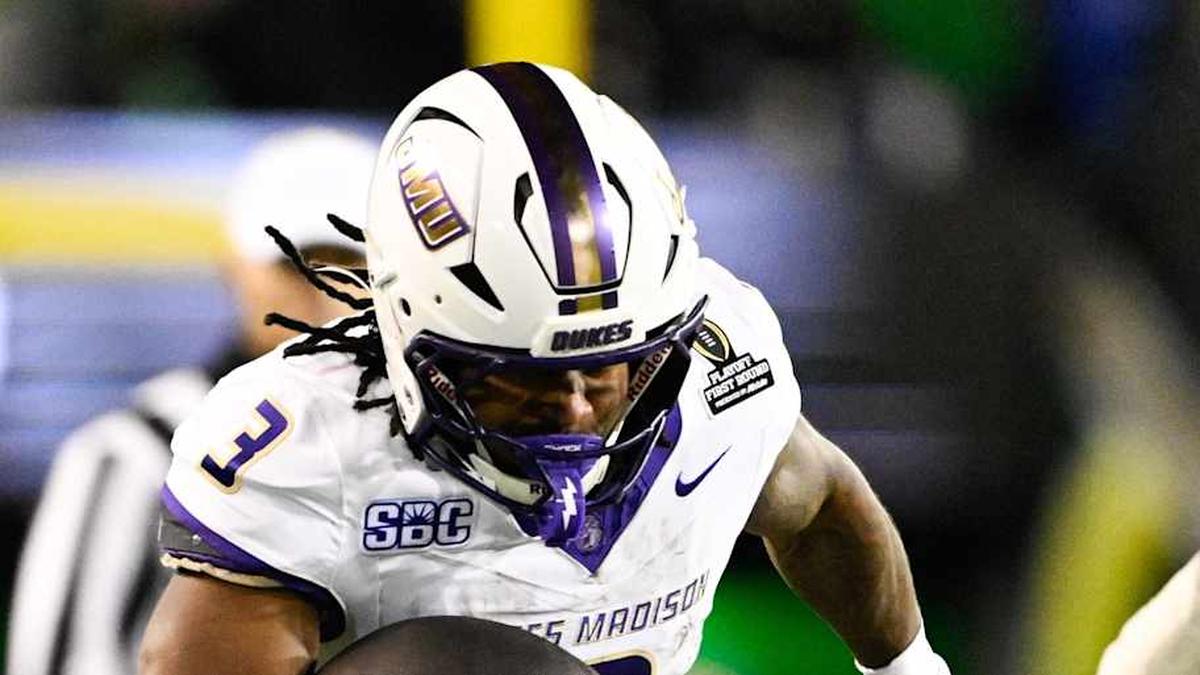  Dec 20, 2025; Eugene, OR, USA; James Madison Dukes running back Wayne Knight (3) rushes as Oregon Ducks defensive back Aaron Flowers (21) defends during the second quarter at Autzen Stadium. Mandatory Credit: Troy Wayrynen-Imagn Images | Troy Wayrynen-Imagn Images 
