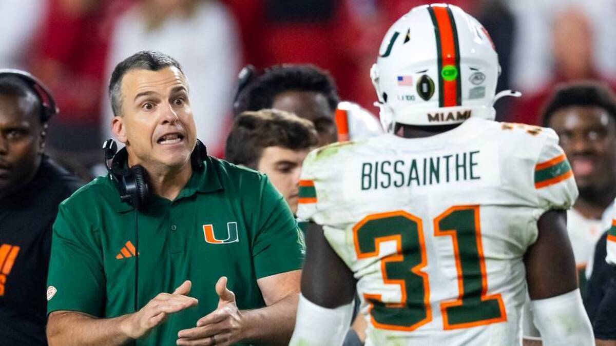  Jan 19, 2026; Miami Gardens, FL, USA; Miami Hurricanes head coach Mario Cristobal with linebacker Wesley Bissainthe (31) against the Indiana Hoosiers during the College Football Playoff National Championship game at Hard Rock Stadium. Mandatory Credit: Mark J. Rebilas-Imagn Images | IMAGN IMAGES via Reuters Connect 