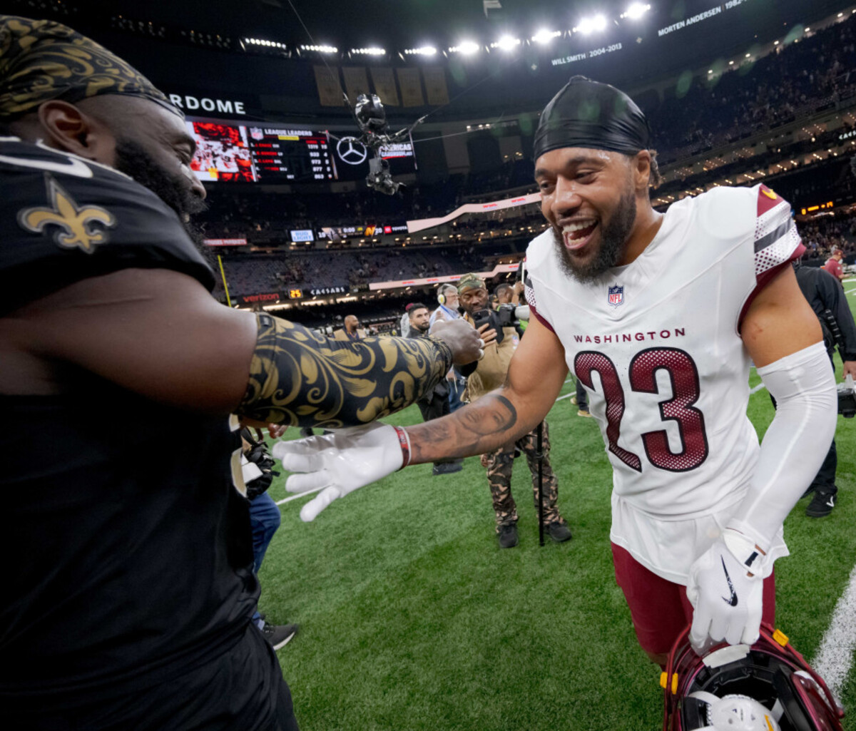  New Orleans Saints linebacker Demario Davis (56) greets former teammate Washington Commanders cornerback Marshon Lattimore (23) at the end of the game. © Matthew Hinton-Imagn Images