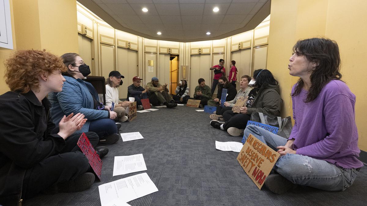 Activists sing and hold signs while sitting in a circle in the front lobby of Sheriff Rochelle Bilal’s office in Philadelphia on Thursday, April 2, 2026. (Jose F. Moreno/The Philadelphia Inquirer/TNS)