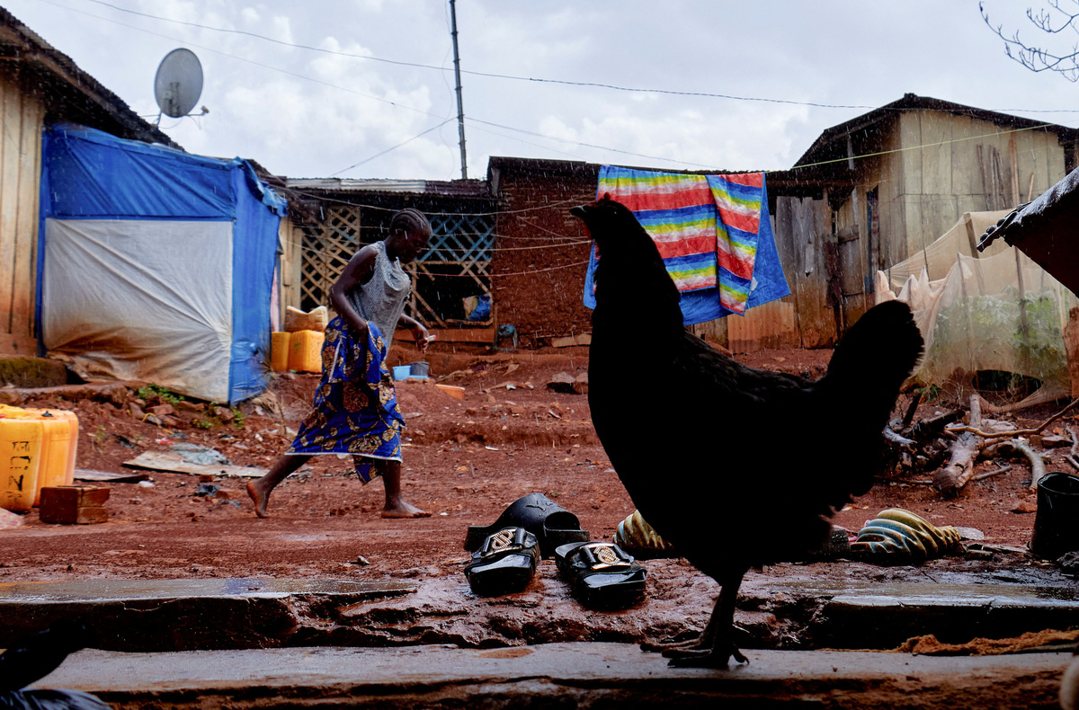 Sister to the late Congolese Pastor Paluku known as "Jeune Patron", whom local authorities believe could be one of the first victims of a new Ebola outbreak involving the Bundibugyo strain and died on February 3, 2026, walks at their courtyard in Quartier Shuni 1, a residential sector, in Mongbwalu, Djugu Territory of Ituri province, Democratic Republic of the Congo, June 4, 2026. REUTERS/Gradel Muyisa Mumbere