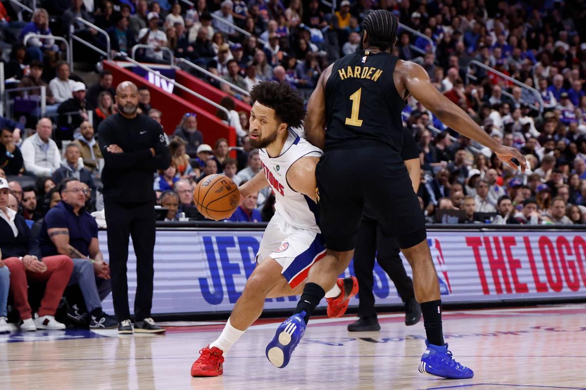  Detroit Pistons guard Cade Cunningham (2) dribbles defended by Cleveland Cavaliers guard James Harden (1). 