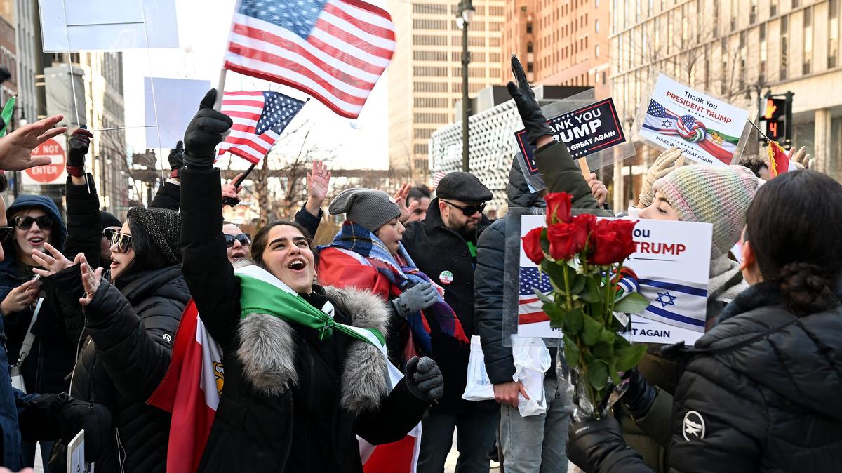 Reyhanegh Mohammadbeigy, 29, left, of West Bloomfield, Michigan, dances and sings with a large group during a rally celebrating the U.S. strikes in Iran at Campus Martius in Detroit on Sunday, March 1, 2026. (Robin Buckson/The Detroit News/TNS)