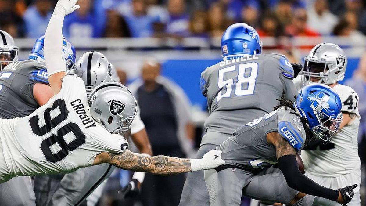  Detroit Lions running back Jahmyr Gibbs is tackled by Las Vegas Raiders defensive end Maxx Crosby during the second half at Ford Field in Detroit on Monday, Oct. 30, 2023. | Junfu Han / USA TODAY NETWORK via Imagn Images 