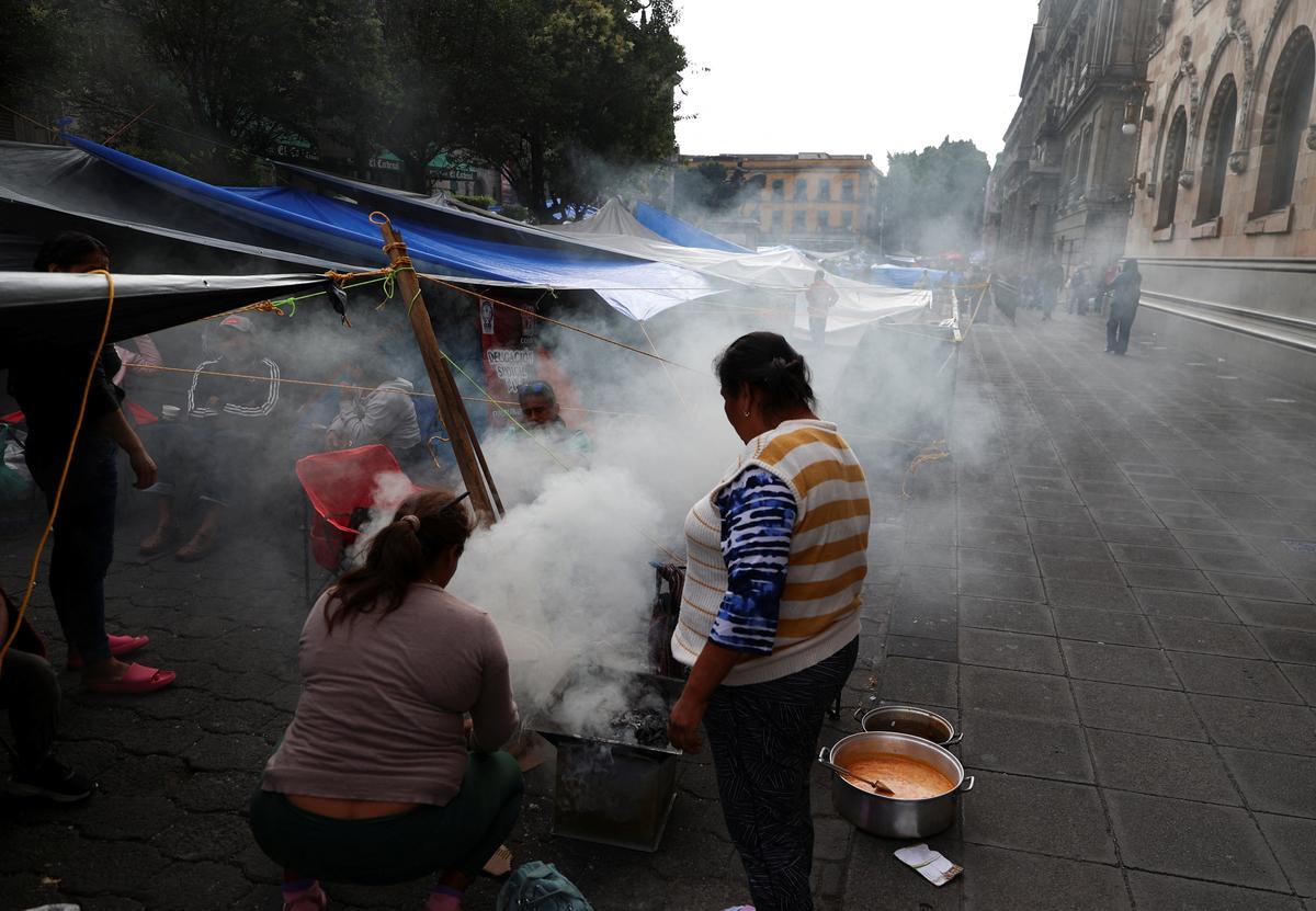People at the encampment set up by the dissident teachers from Mexico's National Coordination of Education Workers (CNTE) union to demand higher wages and pensions, ahead of the 2026 FIFA World Cup, in Mexico City, Mexico, June 3, 2026. REUTERS/Luis Cortes