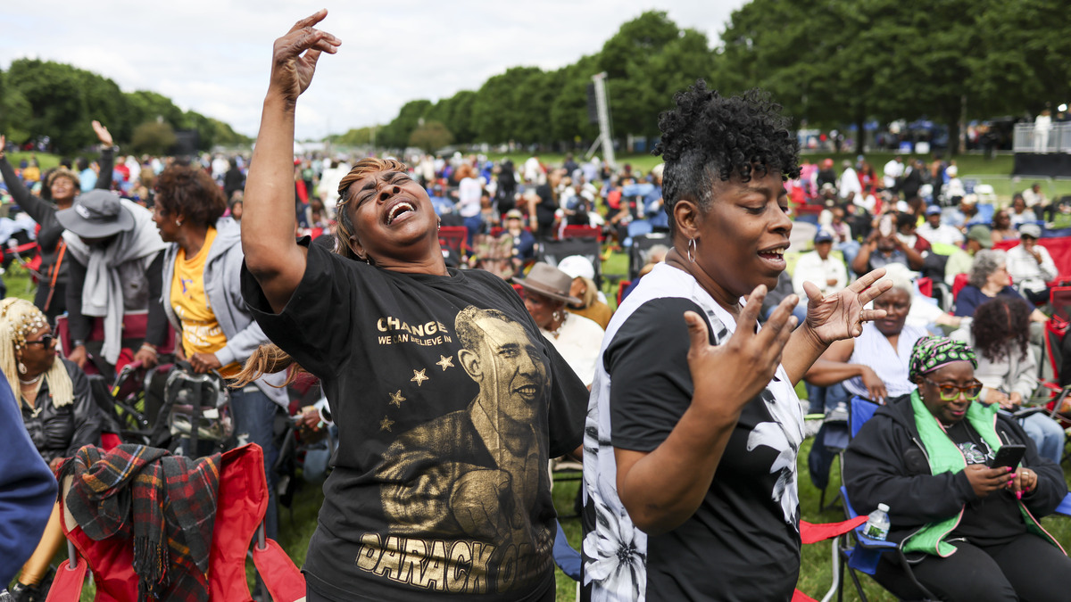 Marlene Snipes, left, and Margaret Pulley dance to music before the Obama Presidential Center's grand opening ceremony watch party at Midway Plaisance Park in Hyde Park on June 18, 2026. (Eileen T. Meslar/Chicago Tribune/TNS)