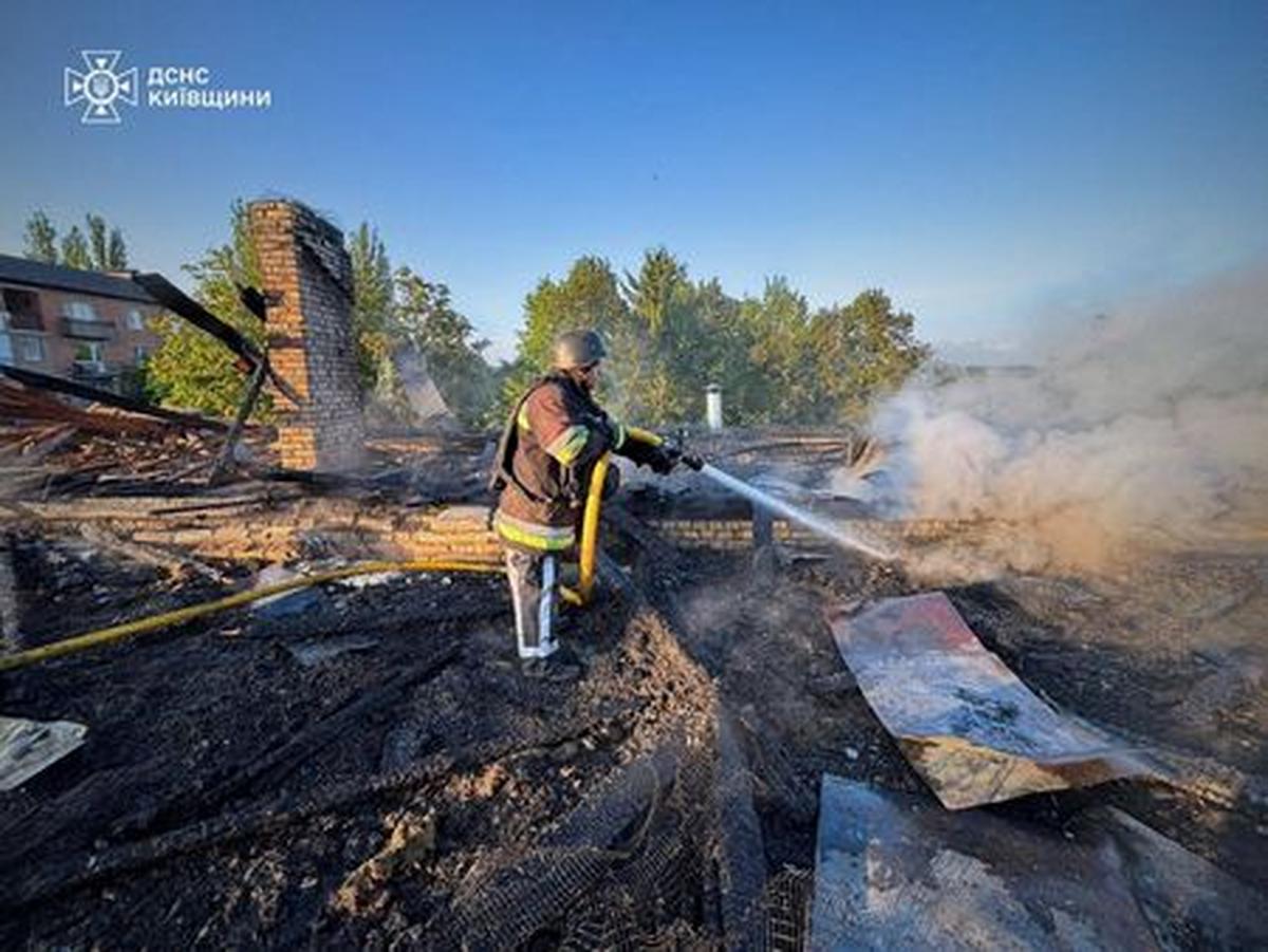 A firefighter works at the site of a kindergarten damaged during a Russian drone strike, amid Russia's attack on Ukraine, in Kyiv region, Ukraine May 12, 2026. Press service of the State Emergency Service of Ukraine in Kyiv region/Handout via REUTERS