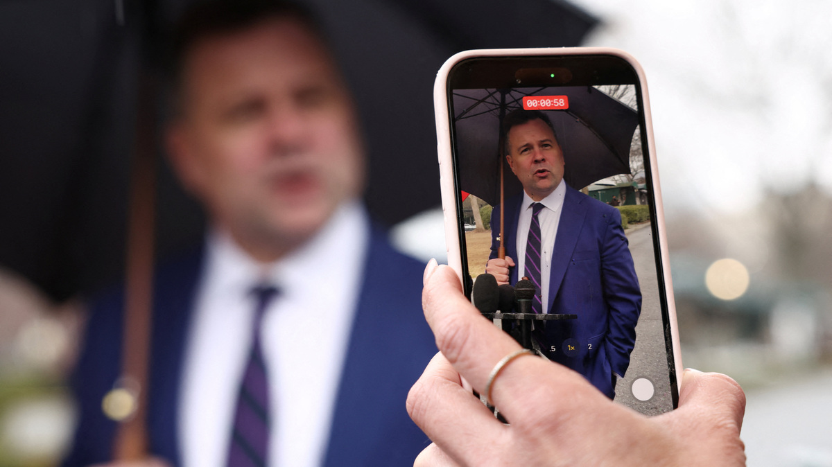 A reporter films with her phone as U.S. Federal Housing Finance Agency Director Bill Pulte speaks with reporters at the White House in Washington, D.C., U.S., January 9, 2026.  REUTERS/Kevin Lamarque