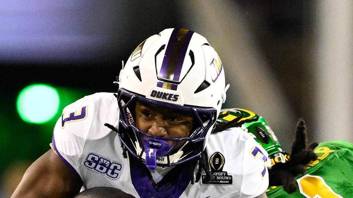  Dec 20, 2025; Eugene, OR, USA; James Madison Dukes running back Wayne Knight (3) rushes as Oregon Ducks defensive back Aaron Flowers (21) defends during the second quarter at Autzen Stadium. Mandatory Credit: Troy Wayrynen-Imagn Images | Troy Wayrynen-Imagn Images 